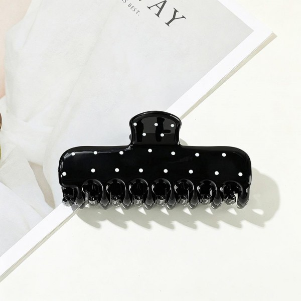 Dotted claw clip in a soft matte acrylic with a wide jaw and long teeth that hold thick hair in a single twist. The scattered dot print keeps it playful without being loud, so it works for the office as easily as a weekend. A smooth finish means no snagging when it comes back out at the end of the day. Printed claw clips are a dependable impulse item that customers buy in multiples.