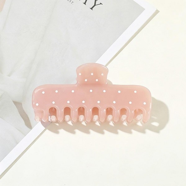 Dotted claw clip in a soft matte acrylic with a wide jaw and long teeth that hold thick hair in a single twist. The scattered dot print keeps it playful without being loud, so it works for the office as easily as a weekend. A smooth finish means no snagging when it comes back out at the end of the day. Printed claw clips are a dependable impulse item that customers buy in multiples.