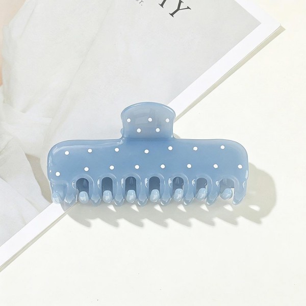 Dotted claw clip in a soft matte acrylic with a wide jaw and long teeth that hold thick hair in a single twist. The scattered dot print keeps it playful without being loud, so it works for the office as easily as a weekend. A smooth finish means no snagging when it comes back out at the end of the day. Printed claw clips are a dependable impulse item that customers buy in multiples.