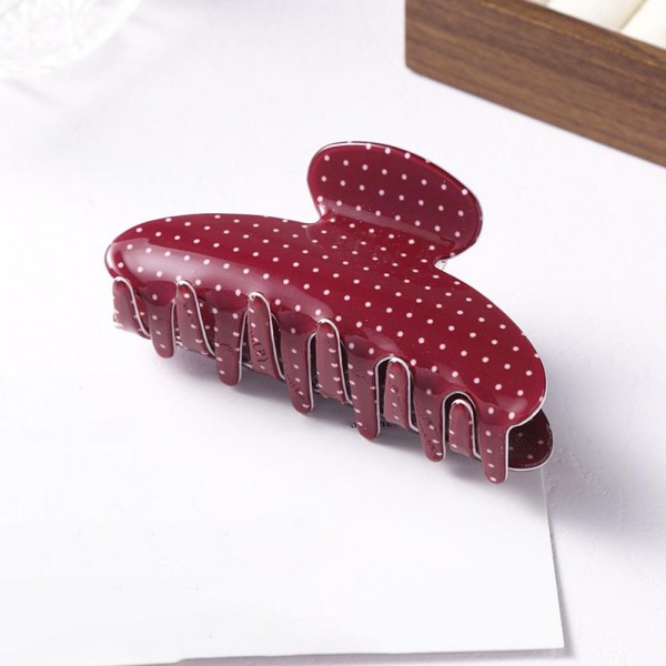 Polka dot claw clip molded in glossy acrylic with deep interlocking teeth and a strong spring that holds a full twist without slipping. Wide enough for thick hair yet slim enough to keep a low profile at the back of the head. The printed finish dresses up a work bun or a wet hair day in a single motion. Printed claw clips are an easy impulse pickup and they reorder consistently.