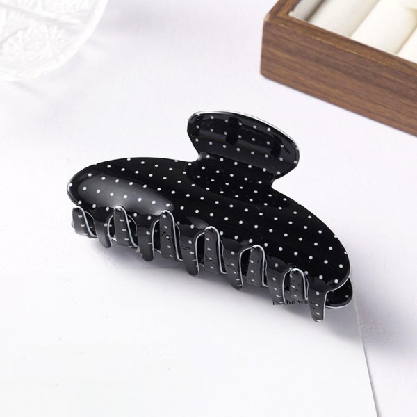 Polka dot claw clip molded in glossy acrylic with deep interlocking teeth and a strong spring that holds a full twist without slipping. Wide enough for thick hair yet slim enough to keep a low profile at the back of the head. The printed finish dresses up a work bun or a wet hair day in a single motion. Printed claw clips are an easy impulse pickup and they reorder consistently.