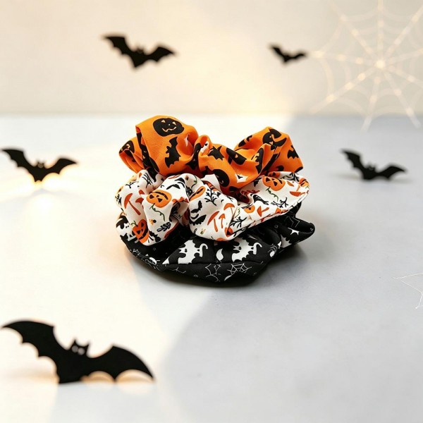 Halloween print scrunchie set that ships as a coordinated multipack, so customers get several looks in one pickup. The soft gathered fabric holds a ponytail or a bun without creasing hair or pulling at the roots. Seasonal prints turn an ordinary hair tie into part of the costume for school parties, trunk or treat nights, and office dress up days. Scrunchie sets are a proven register impulse right through October.
