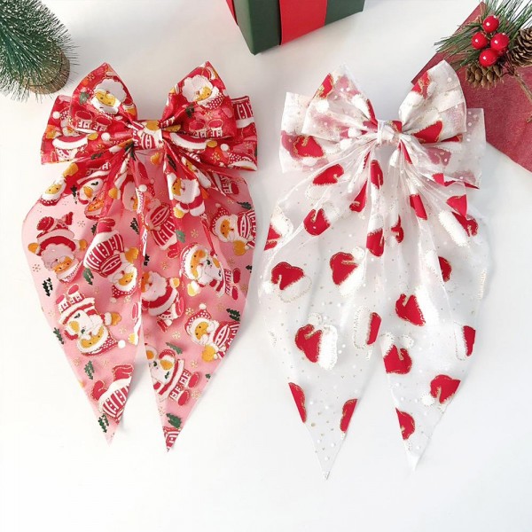 Holiday print bow hair clip with long trailing tails and a snap base that holds securely in fine or thick hair. The seasonal print gives an instant festive touch to a ponytail or a half up style with no effort at all. Lightweight enough to wear through a full day of parties, dinners, and photos. Holiday hair bows are a reliable impulse buy from the first display change through Christmas week.