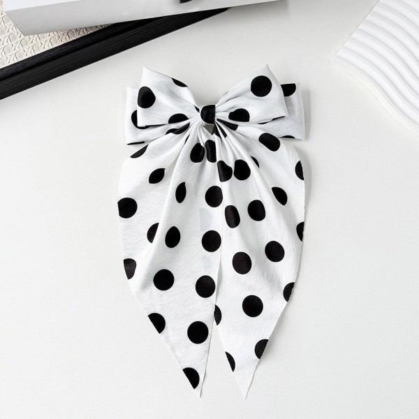 Long tail bow hair clip with a polka dot print and a secure snap base that grips fine and thick hair alike. The flowing tails add movement to a low ponytail, a half up style, or a simple braid. A lightweight satin finish keeps it comfortable enough to forget about during a long day. Bow clips like this are an easy impulse pickup and they merchandise well on a peg display.