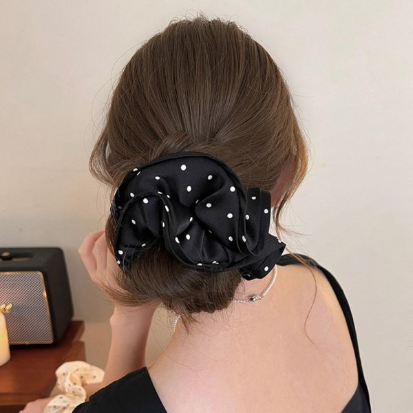 Pin Dot Satin Scrunchie with a smooth, silky finish, a delicate tiny dot print, and a soft elastic core that holds ponytails and buns without creasing or tugging. The full, gathered shape adds instant polish to a simple ponytail and doubles as a cute wrist accessory. Gentle on hair for everyday wear, workouts, and sleep. An easy, affordable add on that customers love to grab in multiples.