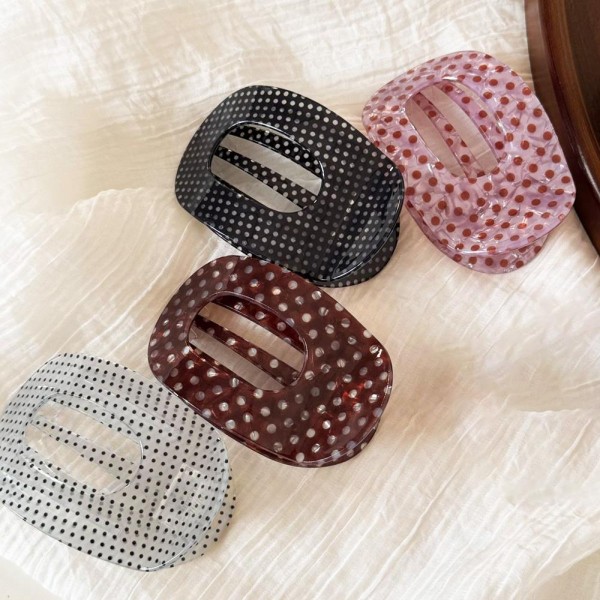 Pin Dot Translucent Flat Claw Clip with a glossy see through finish, an open oval center, and secure interlocking teeth. The flat profile stays comfortable against the head while holding twists, low buns, and half up styles in place all day. Tiny dots add a subtle pattern that works with everyday outfits and dressier looks alike. An affordable, trend right hair accessory that boutique shoppers love to buy in multiples.