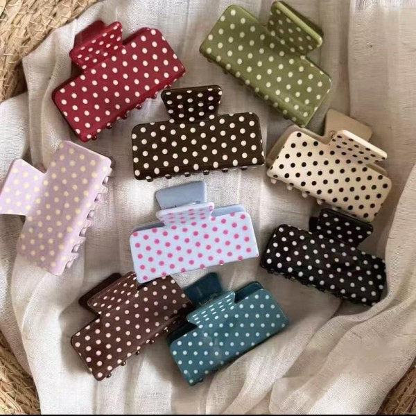Polka Dot Rectangle Claw Clip with a glossy finish, a sturdy spring hinge, and grippy interlocking teeth that hold medium to thick hair securely. The square silhouette is a modern take on the classic claw and works for French twists, low buns, and quick half up styles. Wear one solo or mix several shades for a playful stack. A trendy, affordable hair accessory that sells in multiples and refreshes any countertop display.