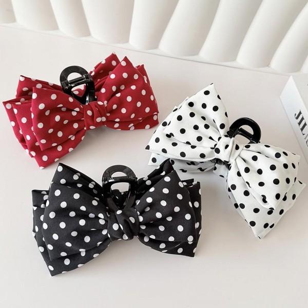 Polka Dot Bow Claw Clip featuring a layered fabric bow in a classic dot print mounted on a sturdy mini claw. It secures half up styles, low buns, and braids in seconds while adding a playful vintage touch. Perfect for school days, brunch dates, and holiday photos. An on trend bow accessory that sells quickly as a register add on and makes an easy stocking stuffer.
