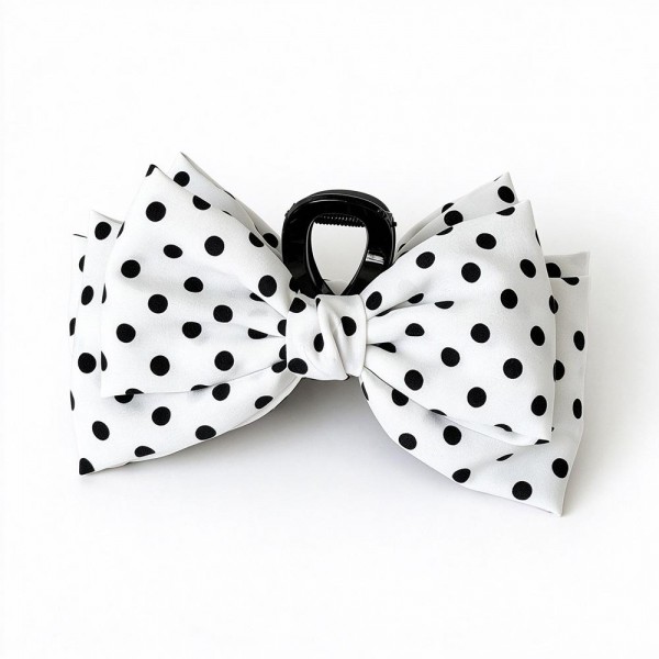 Polka Dot Bow Claw Clip featuring a layered fabric bow in a classic dot print mounted on a sturdy mini claw. It secures half up styles, low buns, and braids in seconds while adding a playful vintage touch. Perfect for school days, brunch dates, and holiday photos. An on trend bow accessory that sells quickly as a register add on and makes an easy stocking stuffer.