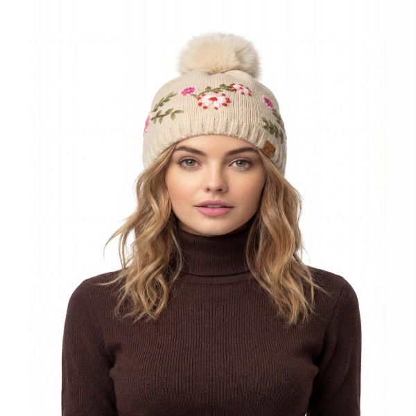Floral Embroidered Pom Beanie with a stitched vine of tiny blossoms and leaves circling the crown, topped with a fluffy faux fur pom. The soft, stretchy knit keeps a smooth, fitted shape and finishes with a ribbed band that sits comfortably over the ears. A sweet, cottage inspired look for holiday markets, school drop offs, and cozy weekend outings. Embroidered beanies pop on the hat wall and are an easy pick for gift shoppers all season long.