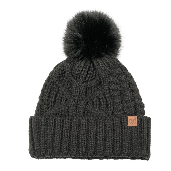 Cable Knit Pom Beanie with a bold braided cable running up the front and a tall ribbed cuff that folds over for a double layer of warmth. A plump faux fur pom finishes the top, and a small faux leather patch adds a polished touch at the cuff. Made for chilly game days, holiday shopping, and weekend getaways. Cable knit pom beanies are a proven winter best seller and an easy reorder for any boutique hat wall.