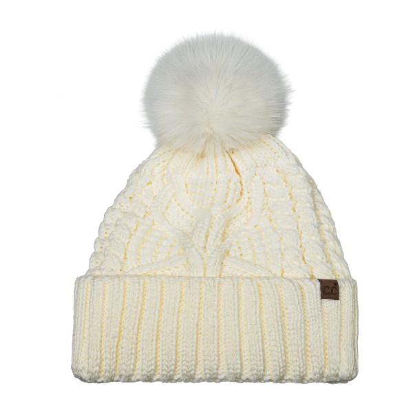 Cable Knit Pom Beanie with a bold braided cable running up the front and a tall ribbed cuff that folds over for a double layer of warmth. A plump faux fur pom finishes the top, and a small faux leather patch adds a polished touch at the cuff. Made for chilly game days, holiday shopping, and weekend getaways. Cable knit pom beanies are a proven winter best seller and an easy reorder for any boutique hat wall.
