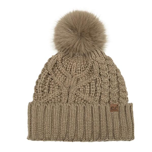 Cable Knit Pom Beanie with a bold braided cable running up the front and a tall ribbed cuff that folds over for a double layer of warmth. A plump faux fur pom finishes the top, and a small faux leather patch adds a polished touch at the cuff. Made for chilly game days, holiday shopping, and weekend getaways. Cable knit pom beanies are a proven winter best seller and an easy reorder for any boutique hat wall.