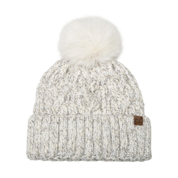 Marled Cable Knit Pom Beanie with a chunky twisted cable texture, a ribbed fold over cuff, and a fluffy faux fur pom on top. The soft heathered yarn has a cozy, handknit look that pairs with puffers, parkas, and wool coats. Perfect for ski trips, holiday markets, school pickups, and everyday winter wear. Pom beanies are a top cold weather seller and an easy stocking stuffer customers buy in multiples.