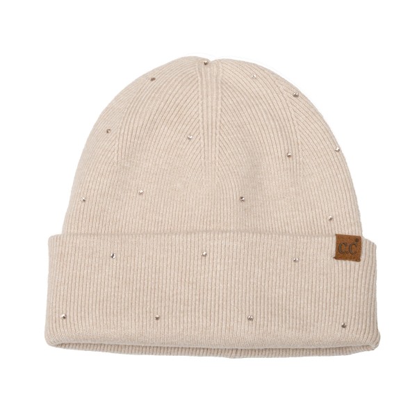 Rhinestone Studded Cuffed Beanie in a soft, fine rib knit dotted with tiny sparkling studs from crown to cuff. The smooth fold over cuff sits neatly at the brow, and a small faux leather patch adds a finished touch. Just enough shine for holiday parties, date nights, and everyday errands. A dressed up take on the classic beanie that sells as a gift and as a closet staple, so it moves quickly on any accessory wall.
