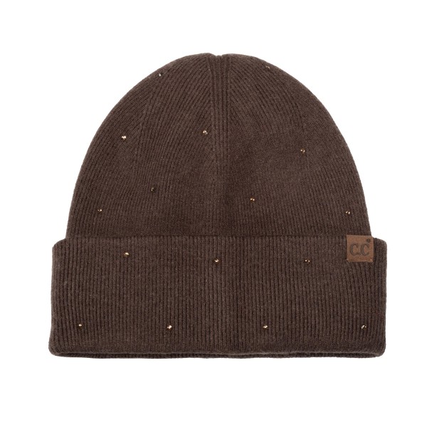 Rhinestone Studded Cuffed Beanie in a soft, fine rib knit dotted with tiny sparkling studs from crown to cuff. The smooth fold over cuff sits neatly at the brow, and a small faux leather patch adds a finished touch. Just enough shine for holiday parties, date nights, and everyday errands. A dressed up take on the classic beanie that sells as a gift and as a closet staple, so it moves quickly on any accessory wall.