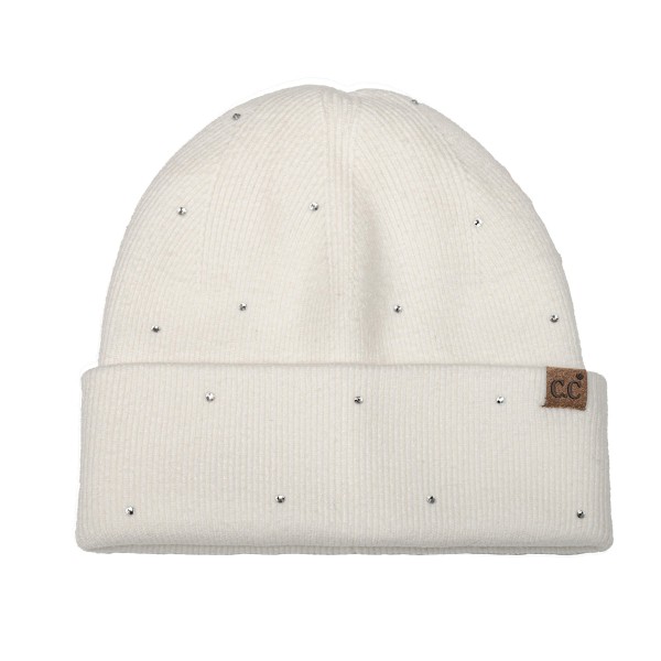 Rhinestone Studded Cuffed Beanie in a soft, fine rib knit dotted with tiny sparkling studs from crown to cuff. The smooth fold over cuff sits neatly at the brow, and a small faux leather patch adds a finished touch. Just enough shine for holiday parties, date nights, and everyday errands. A dressed up take on the classic beanie that sells as a gift and as a closet staple, so it moves quickly on any accessory wall.