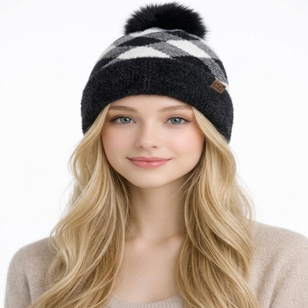 Buffalo Check Pom Beanie with a bold plaid knit crown, a solid ribbed fold over cuff, and an oversized faux fur pom on top. The soft stretch knit keeps ears warm and fits most adults comfortably. Made for tailgates, holiday markets, cabin weekends, and snowy school pickups. Plaid pom beanies are a classic winter seller and a go to stocking stuffer for teens, moms, and friends.