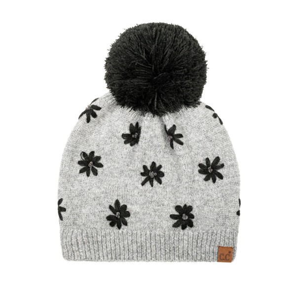 Daisy Knit Pom Beanie with a scattered flower motif knit right into the fabric for a soft, vintage inspired look. A fluffy pom sits on top, and the ribbed band hugs the head for a snug, comfortable fit with no bulky cuff. Sweet for school drop offs, pumpkin patch trips, and holiday markets. Floral knit beanies are a feel good gift that appeals to every age, so this style sells through quickly from fall into winter.