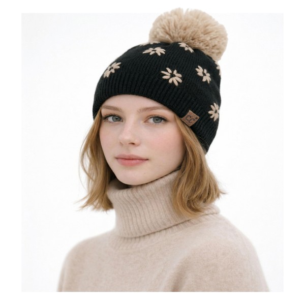 Daisy Knit Pom Beanie with a scattered flower motif knit right into the fabric for a soft, vintage inspired look. A fluffy pom sits on top, and the ribbed band hugs the head for a snug, comfortable fit with no bulky cuff. Sweet for school drop offs, pumpkin patch trips, and holiday markets. Floral knit beanies are a feel good gift that appeals to every age, so this style sells through quickly from fall into winter.