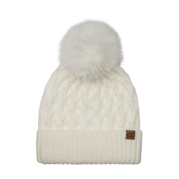 Lattice Cable Knit Pom Beanie with an allover diamond cable texture in a soft heathered yarn, topped with a plush faux fur pom. The ribbed band folds up for a snug double layer over the ears, and a small faux leather patch adds a finished look. A cozy favorite for holiday shopping, tailgates, and snowy weekend walks. Textured pom beanies are a top seller every winter and make an easy, giftable add on at the register.