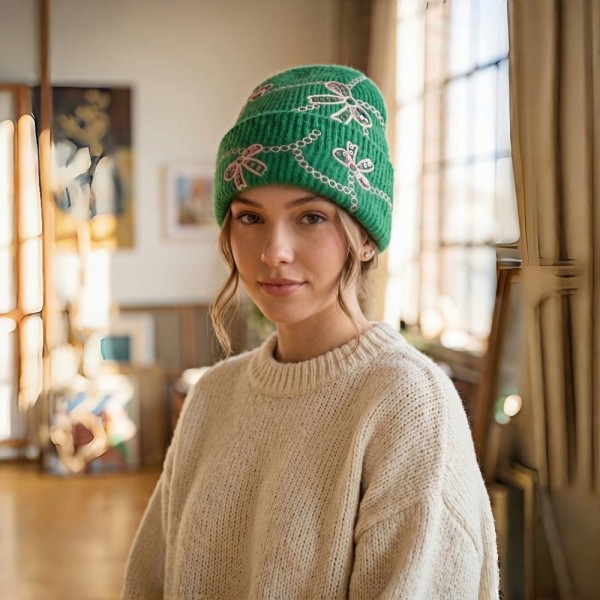 Add a sweet and sparkly finish to cold weather looks with this bow embroidered knit beanie, featuring delicate sequin bows linked by a scalloped chain design across a soft, fuzzy ribbed knit. The fold over cuff offers extra warmth around the ears and a relaxed, slouchy fit that flatters every face. A charming seasonal favorite that pairs beautifully with sweaters and wool coats, perfect for holiday gifting and boutique displays.