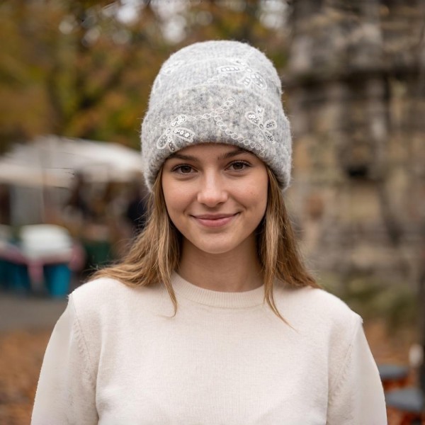 Add a sweet and sparkly finish to cold weather looks with this bow embroidered knit beanie, featuring delicate sequin bows linked by a scalloped chain design across a soft, fuzzy ribbed knit. The fold over cuff offers extra warmth around the ears and a relaxed, slouchy fit that flatters every face. A charming seasonal favorite that pairs beautifully with sweaters and wool coats, perfect for holiday gifting and boutique displays.