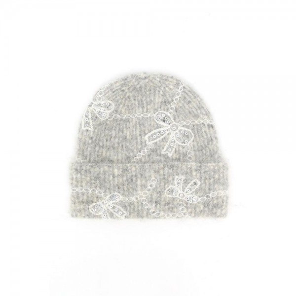Add a sweet and sparkly finish to cold weather looks with this bow embroidered knit beanie, featuring delicate sequin bows linked by a scalloped chain design across a soft, fuzzy ribbed knit. The fold over cuff offers extra warmth around the ears and a relaxed, slouchy fit that flatters every face. A charming seasonal favorite that pairs beautifully with sweaters and wool coats, perfect for holiday gifting and boutique displays.