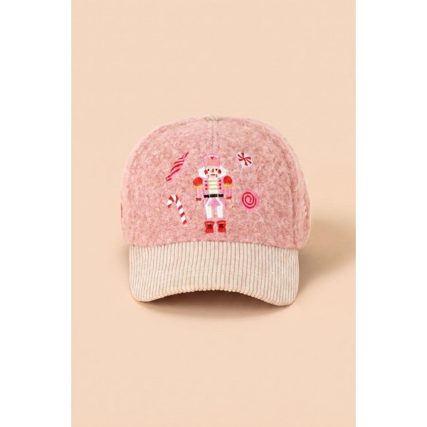 Nutcracker Embroidered Baseball Cap in a soft boucle knit with a contrast corduroy brim. Detailed embroidery pairs a classic nutcracker figure with candy canes and peppermint swirls for a full holiday scene across the front. An adjustable back strap fits most, and the plush texture reads instantly seasonal on a hat display. An easy impulse grab for holiday markets, teacher gifts, and Christmas parade weekends.