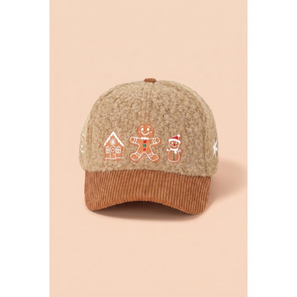 Gingerbread Embroidered Baseball Cap with a soft boucle crown and coordinating corduroy brim. An embroidered gingerbread house, gingerbread man, and gingerbread snowman line the front for a sweet baking season look. An adjustable back strap fits most. Perfect for cookie exchanges, holiday baking parties, and cozy December weekends, and an easy add on at the register.