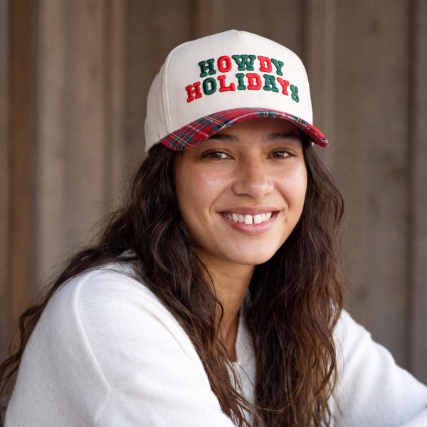 Saddle up for the season with this Howdy Holidays trucker cap, featuring bold embroidered lettering across a structured front panel with breathable mesh in the back. A playful western holiday look that pairs perfectly with cozy sweaters, flannels, and denim. The adjustable snapback closure delivers a comfortable fit for most head sizes, making it an easy gift and a festive seasonal favorite for boutiques and gift shops.