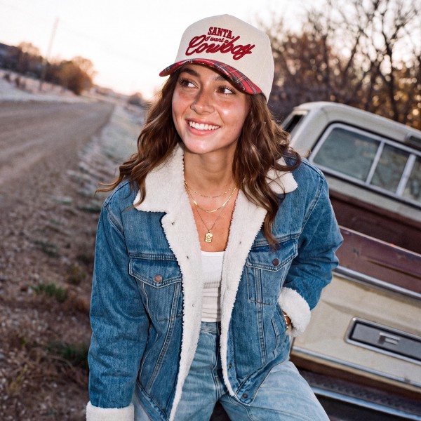 Add a little country charm to holiday outfits with this Santa I Want a Cowboy baseball cap, finished with bold embroidered script lettering on a structured front panel and a contrast curved brim. A fun and flirty seasonal statement that looks great with denim, sherpa jackets, and cozy knits. The adjustable back closure offers a comfortable fit for most head sizes, making it a standout gift and a festive favorite for boutiques and gift shops.