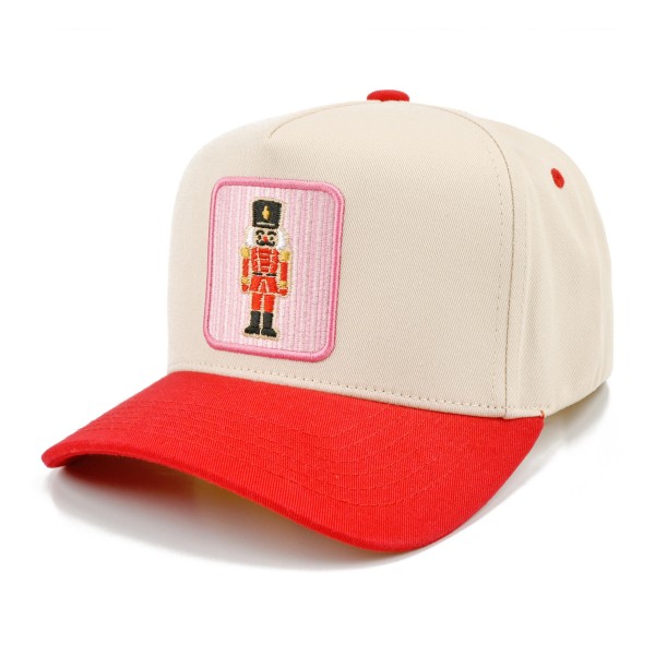 Bring a touch of classic holiday charm to any outfit with this nutcracker patch baseball cap, featuring a framed embroidered nutcracker soldier on a structured front panel paired with a contrast curved brim. A sweet and nostalgic seasonal accent that pairs beautifully with cozy sweaters, puffers, and denim. The adjustable back closure provides a comfortable fit for most head sizes, making it a charming gift and a festive favorite for boutiques and gift shops.