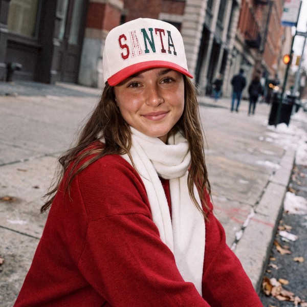 Spell out holiday spirit with this SANTA patchwork baseball cap, featuring oversized varsity letters stitched from mixed festive fabrics across a structured front panel with a contrast curved brim. A cheerful statement piece that pairs easily with sweaters, scarves, and winter coats. The adjustable back closure offers a comfortable fit for most head sizes, making it a fun gift and a festive favorite for boutiques and gift shops.