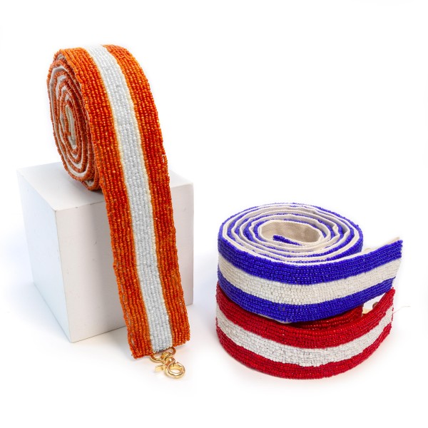 Orange And White Beaded Accent Bag Strap 

- Approximately 55" L
- Approximately 1.5" W
- Lobster Claw Attachment
- 100% Cotton Canvas Backing
- Spot Clean Only