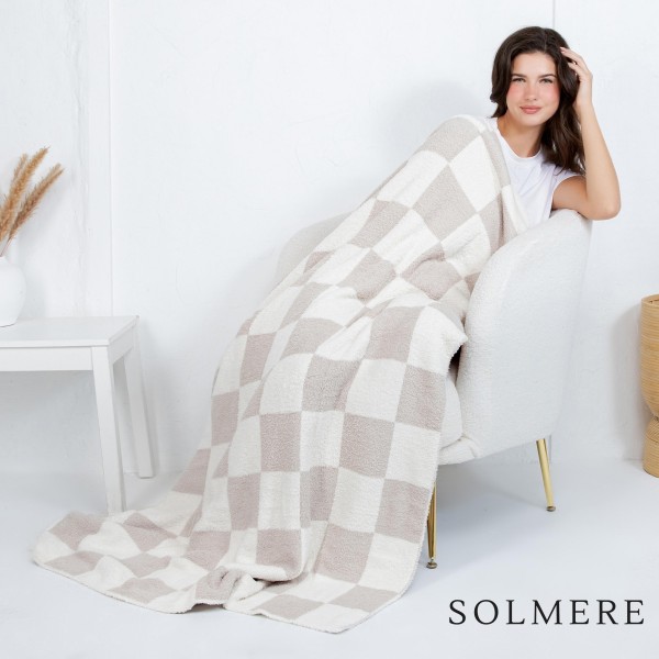 Solmere Blanket – Checkered Print Blanket

Wrap yourself in pure indulgence. Our Solmere Blanket combines a fashion-forward design with an irresistibly soft hand-feel that’s as beautiful as it is cozy.

- Luxuriously Soft – Crafted from ultra-plush, high-quality fibers you’ll want to snuggle into all season long.

- Perfectly Sized – Approximately 50” W x 60” L, perfect for draping over your sofa, bed, or yourself.

- Premium Craftsmanship – 100% polyester for lasting softness, warmth, and easy care.

- Thoughtful Packaging – Each blanket is tied with a branded ribbon in a bow and includes two cards: one featuring the SOLMERE brand and another showcasing a high-quality image of the blanket’s print. Individually packaged

Once you touch it, you’ll understand why SOLMERE blankets are love at first feel.
