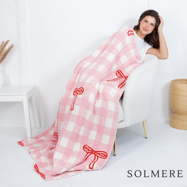 Solmere Blanket – Checked Red Bow Blanket

Wrap yourself in pure indulgence. Our Solmere Blanket combines a fashion-forward design with an irresistibly soft hand-feel that’s as beautiful as it is cozy.

- Luxuriously Soft – Crafted from ultra-plush, high-quality fibers you’ll want to snuggle into all season long.

- Perfectly Sized – Approximately 50” W x 60” L, perfect for draping over your sofa, bed, or yourself.

- Premium Craftsmanship – 100% polyester for lasting softness, warmth, and easy care.

- Thoughtful Packaging – Each blanket is tied with a branded ribbon in a bow and includes two cards: one featuring the SOLMERE brand and another showcasing a high-quality image of the blanket’s print. Individually packaged

Once you touch it, you’ll understand why SOLMERE blankets are love at first feel.
