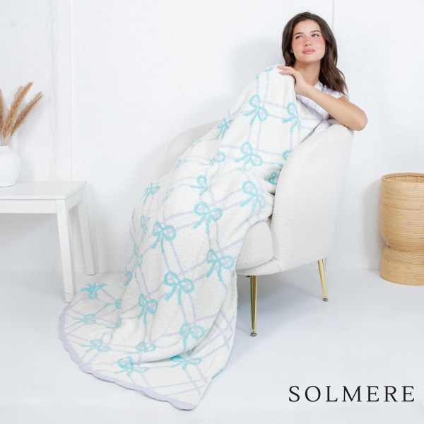 Solmere Blanket – Gridded Bows Blanket

Wrap yourself in pure indulgence. Our Solmere Blanket combines a fashion-forward design with an irresistibly soft hand-feel that’s as beautiful as it is cozy.

- Luxuriously Soft – Crafted from ultra-plush, high-quality fibers you’ll want to snuggle into all season long.

- Perfectly Sized – Approximately 50” W x 60” L, perfect for draping over your sofa, bed, or yourself.

- Premium Craftsmanship – 100% polyester for lasting softness, warmth, and easy care.

- Thoughtful Packaging – Each blanket is tied with a branded ribbon in a bow and includes two cards: one featuring the SOLMERE brand and another showcasing a high-quality image of the blanket’s print. Individually packaged

Once you touch it, you’ll understand why SOLMERE blankets are love at first feel.
