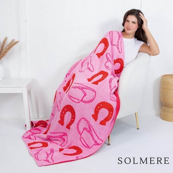 Solmere Blanket – Western Horseshoe Print Blanket

Wrap yourself in pure indulgence. Our Solmere Blanket combines a fashion-forward design with an irresistibly soft hand-feel that’s as beautiful as it is cozy.

- Luxuriously Soft – Crafted from ultra-plush, high-quality fibers you’ll want to snuggle into all season long.

- Perfectly Sized – Approximately 50” W x 60” L, perfect for draping over your sofa, bed, or yourself.

- Premium Craftsmanship – 100% polyester for lasting softness, warmth, and easy care.

- Thoughtful Packaging – Each blanket is tied with a branded ribbon in a bow and includes two cards: one featuring the SOLMERE brand and another showcasing a high-quality image of the blanket’s print. Individually packaged

Once you touch it, you’ll understand why SOLMERE blankets are love at first feel.
