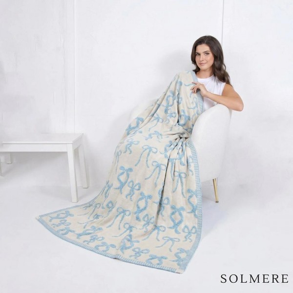 Solmere Blanket – Bow Blanket

Wrap yourself in pure indulgence. Our Solmere Blanket combines a fashion-forward design with an irresistibly soft hand-feel that’s as beautiful as it is cozy.

- Luxuriously Soft – Crafted from ultra-plush, high-quality fibers you’ll want to snuggle into all season long.

- Perfectly Sized – Approximately 50” W x 60” L, perfect for draping over your sofa, bed, or yourself.

- Premium Craftsmanship – 100% polyester for lasting softness, warmth, and easy care.

- Thoughtful Packaging – Each blanket is tied with a branded ribbon in a bow and includes two cards: one featuring the SOLMERE brand and another showcasing a high-quality image of the blanket’s print. Individually packaged

Once you touch it, you’ll understand why SOLMERE blankets are love at first feel.