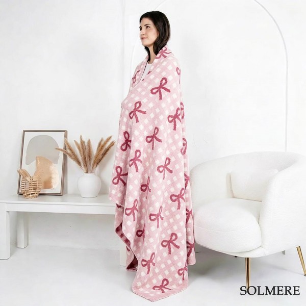 Solmere Blanket – Checker Bow Blanket

Wrap yourself in pure indulgence. Our Solmere Blanket combines a fashion-forward design with an irresistibly soft hand-feel that’s as beautiful as it is cozy.

- Luxuriously Soft – Crafted from ultra-plush, high-quality fibers you’ll want to snuggle into all season long.

- Perfectly Sized – Approximately 50” W x 60” L, perfect for draping over your sofa, bed, or yourself.

- Premium Craftsmanship – 100% polyester for lasting softness, warmth, and easy care.

- Thoughtful Packaging – Each blanket is tied with a branded ribbon in a bow and includes two cards: one featuring the SOLMERE brand and another showcasing a high-quality image of the blanket’s print. Individually packaged

Once you touch it, you’ll understand why SOLMERE blankets are love at first feel.
