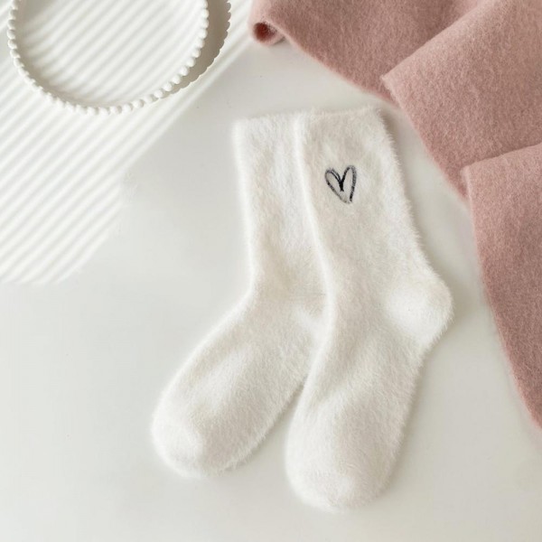 Stock the sweetest gift-ready hosiery on your wall with this assorted six-pack of plush feather-knit crew socks featuring a tiny embroidered heart at the cuff. Spun from a brushed, fuzzy yarn blend that feels irresistibly soft against the skin, each pair adds an instant smile factor with its little hand-drawn heart detail — the kind of design that drives Instagram tags and repeat boutique orders. The mid-calf length and stretch ribbed top layer beautifully with leggings, joggers, and lounge sets. A natural anchor for Valentine displays, bridal party gifts, hostess bundles, and self-care assortments that need a touch of charm.