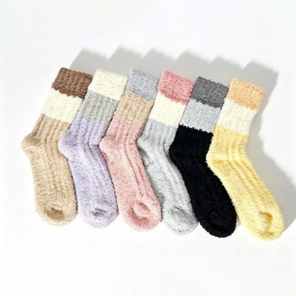 Bring soft-textured, fashion-forward hosiery to your wall with this assorted six-pack of ribbed knit plush crew socks. Each pair is spun from a brushed, fuzzy yarn blend with a vertical rib pattern that adds visual interest and a slimming look on the leg. A contrasting color-block cuff finishes the design and gives every pair a quietly elevated, on-trend feel. The mid-calf length and stretch ribbed top layer easily over leggings, joggers, and ankle boots. A boutique-friendly crowd-pleaser for cozy season — perfect for self-care displays, neighbor gifts, and stocking sets that need a little something extra.