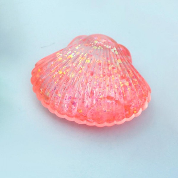 This scallop seashell squishy toy brings seaside charm to any novelty or gift display. Molded with realistic ridged shell detail, it is crafted from soft slow-rise foam that delivers a smooth, satisfying squeeze. Lightweight and compact, it makes a natural impulse buy for coastal boutiques, gift shops, and summer novelty assortments. The detailed shell shape gives it strong shelf presence and broad appeal as a gift, desk toy, or tactile stress reliever. Easy to merchandise in any display setting.