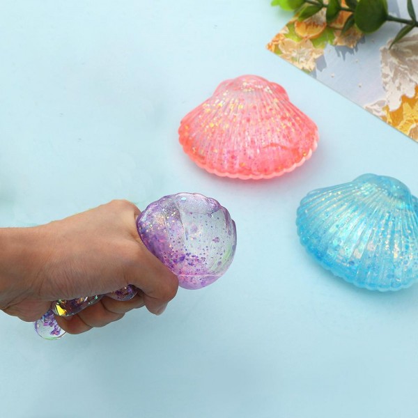 This scallop seashell squishy toy brings seaside charm to any novelty or gift display. Molded with realistic ridged shell detail, it is crafted from soft slow-rise foam that delivers a smooth, satisfying squeeze. Lightweight and compact, it makes a natural impulse buy for coastal boutiques, gift shops, and summer novelty assortments. The detailed shell shape gives it strong shelf presence and broad appeal as a gift, desk toy, or tactile stress reliever. Easy to merchandise in any display setting.