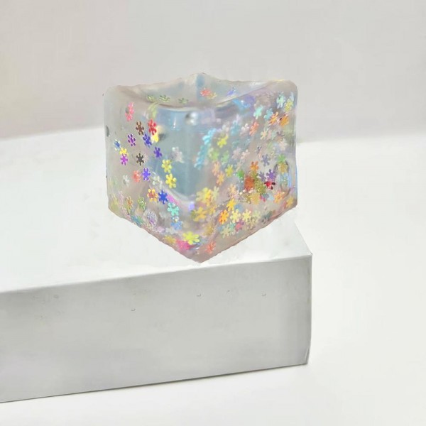 This translucent floral cube squishy toy is a decorative novelty with irresistible shelf appeal. Its soft, clear squeeze body reveals a floating floral confetti design inside, making it as pretty as it is fun to squish. Made from soft, flexible material with a satisfying tactile feel, it appeals to gift buyers, decor enthusiasts, and novelty toy shoppers alike. A standout impulse buy for gift boutiques and novelty retailers — it photographs beautifully and generates strong customer interest.