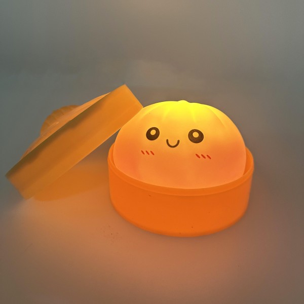 Light Up Dumpling Squishy Toy

Cute novelty squishy toy designed as a smiling dumpling in a bamboo-style steamer. Perfect for gifts, impulse buys, and food-themed novelty displays.

- LED 
- Ages 3+
- Approximately 3" L