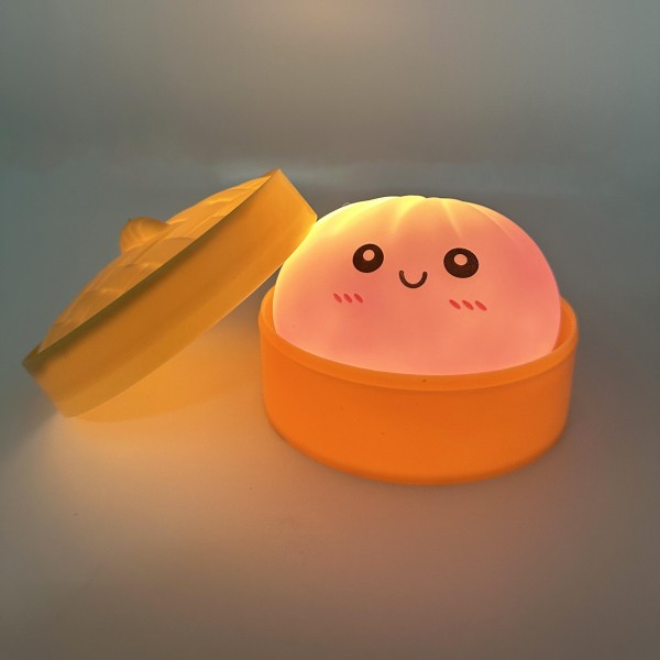 Light Up Dumpling Squishy Toy

Cute novelty squishy toy designed as a smiling dumpling in a bamboo-style steamer. Perfect for gifts, impulse buys, and food-themed novelty displays.

- LED 
- Ages 3+
- Approximately 3" L