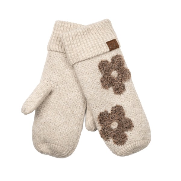 Heathered knit mittens with raised daisy appliques across the back of the hand and a ribbed fold over cuff. The soft, textured knit traps warmth and feels cozy on frosty walks, holiday markets, and school runs. Playful flower details bring a cheerful, retro feel to a practical cold weather basic. A fun gift pick that pairs perfectly with beanies and scarves and sells well in multiples.