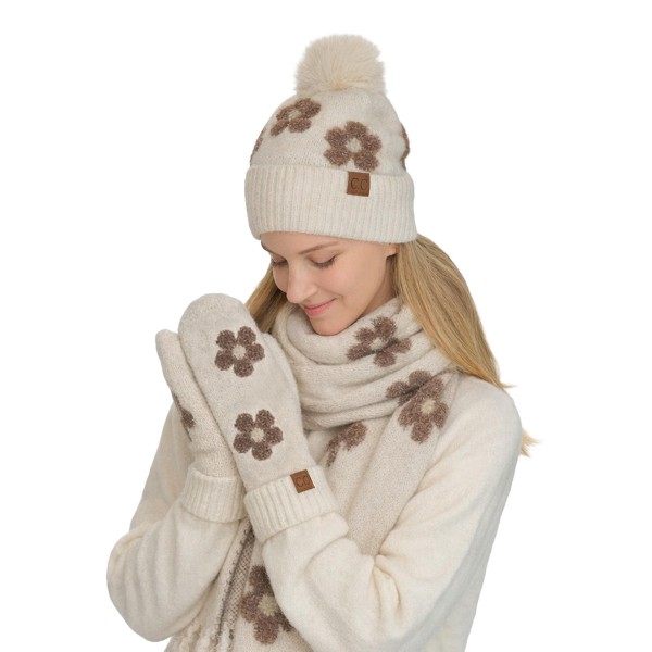 Heathered knit mittens with raised daisy appliques across the back of the hand and a ribbed fold over cuff. The soft, textured knit traps warmth and feels cozy on frosty walks, holiday markets, and school runs. Playful flower details bring a cheerful, retro feel to a practical cold weather basic. A fun gift pick that pairs perfectly with beanies and scarves and sells well in multiples.